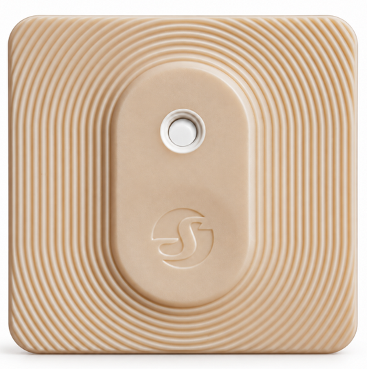 Beige square smart device with textured concentric ripple design, white circular button and embossed logo