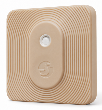 Close-up of beige smart device showing textured ripple surface, central white button and embossed logo